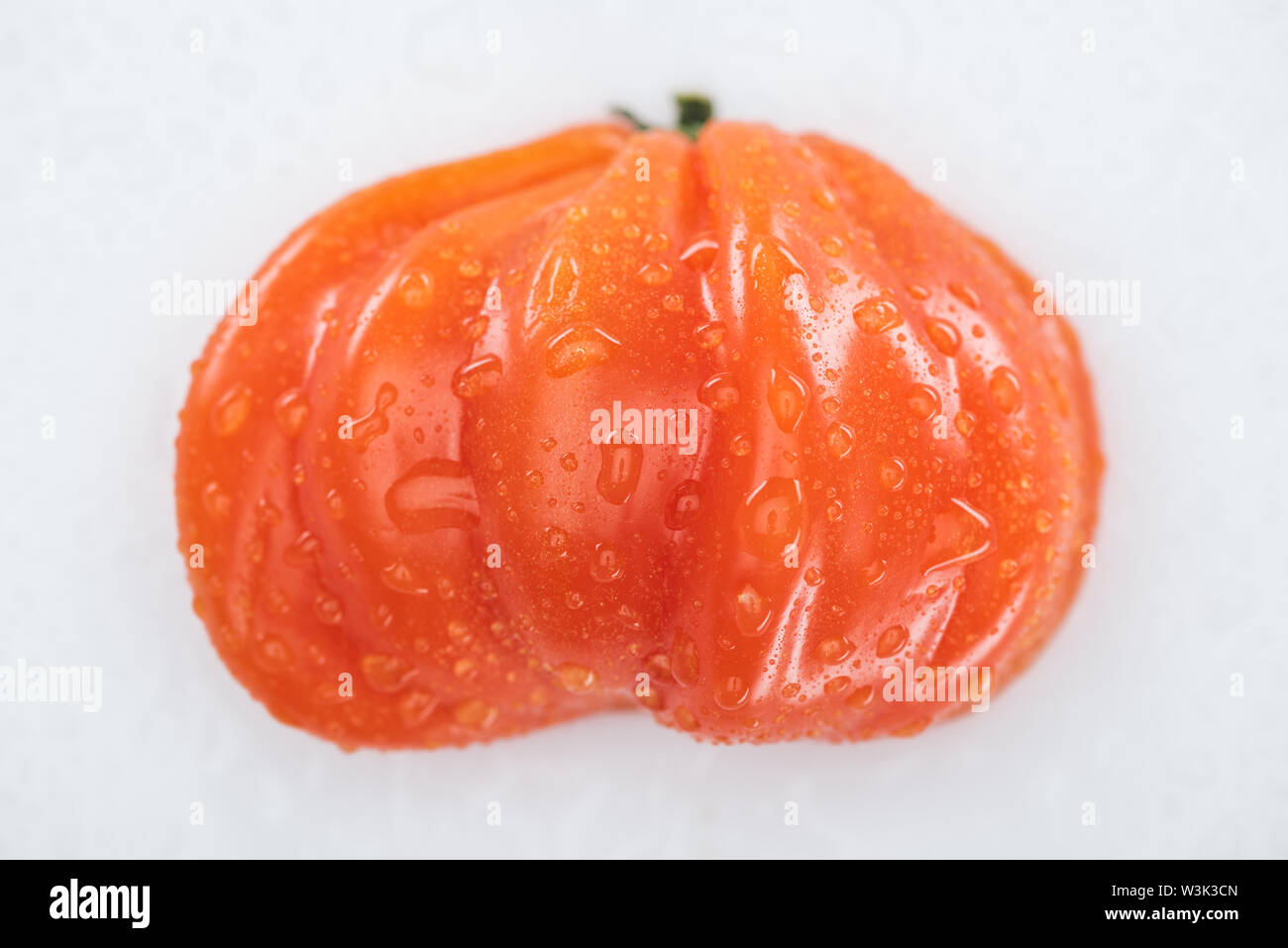 top view of wet red ripe tomato with water drops isolated on white ...