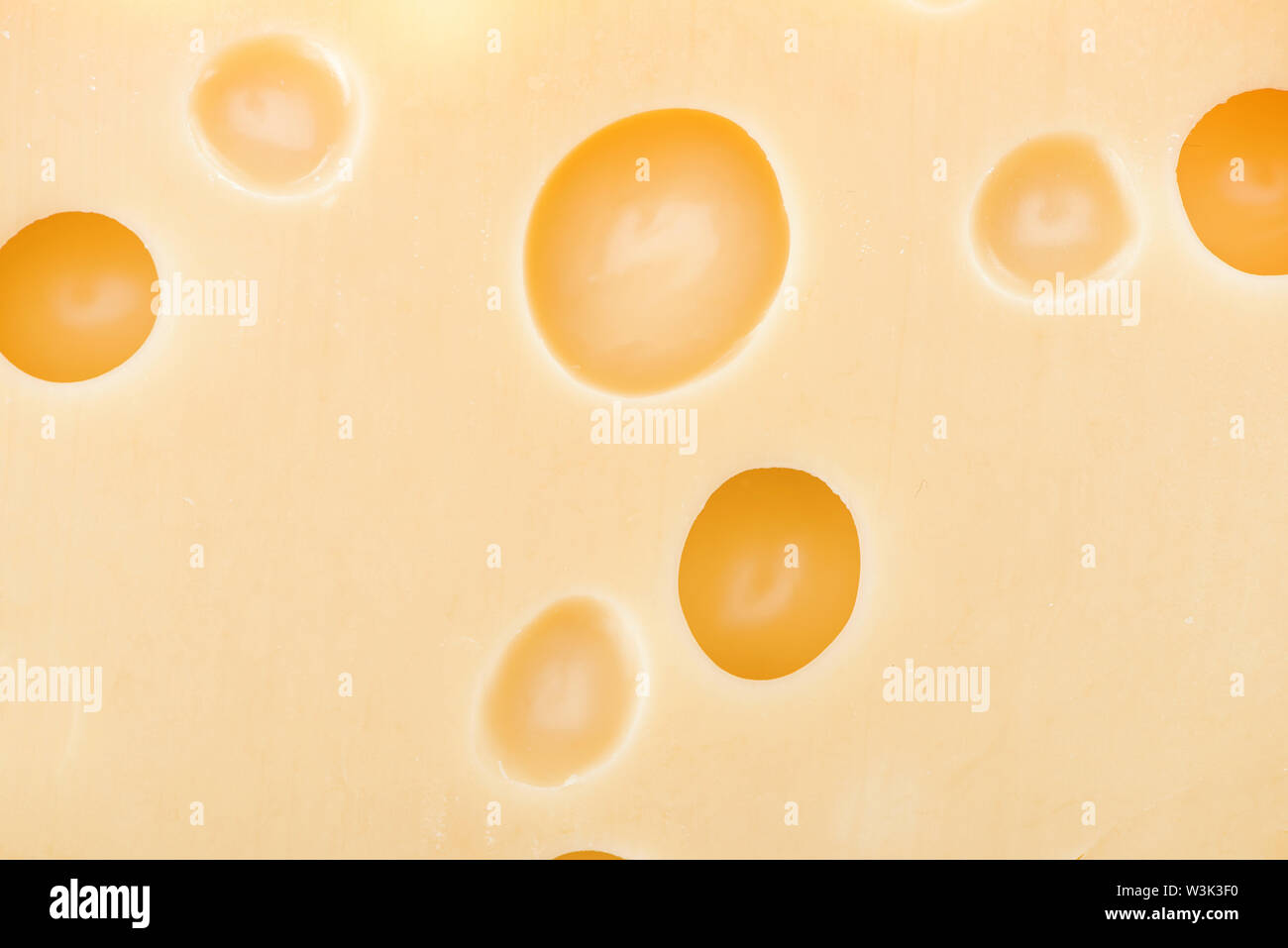 close up view of yellow cheese with wholes Stock Photo