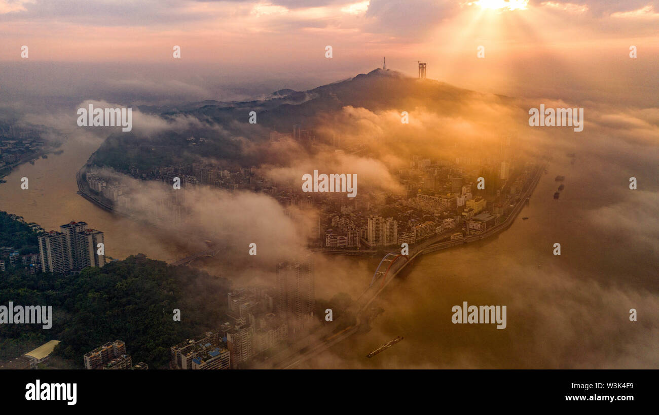 July 15, 2019, Guangxi, China: Early in the morning, the mist and clouds nestle in among the yellow-green Yuan Yang river in Wuzhou city of Guangxi. Credit: SIPA Asia/ZUMA Wire/Alamy Live News Stock Photo
