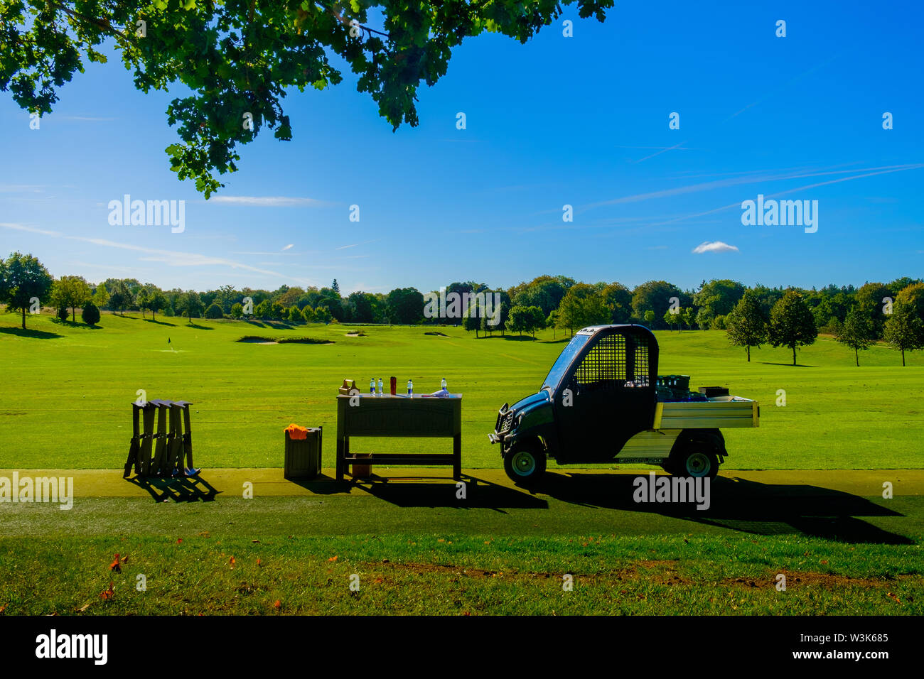 Golf utility vehicle parked by the green of a golf course in Hertfordshire, England Stock Photo