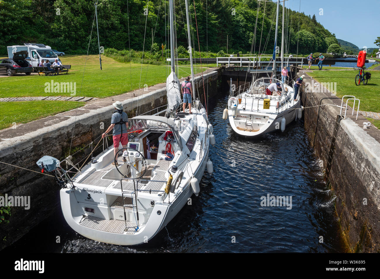 Two yachts within lock 10 as water level is lowered – Dunardry on Crinan Canal, Argyll and Bute, Scotland, UK Stock Photo