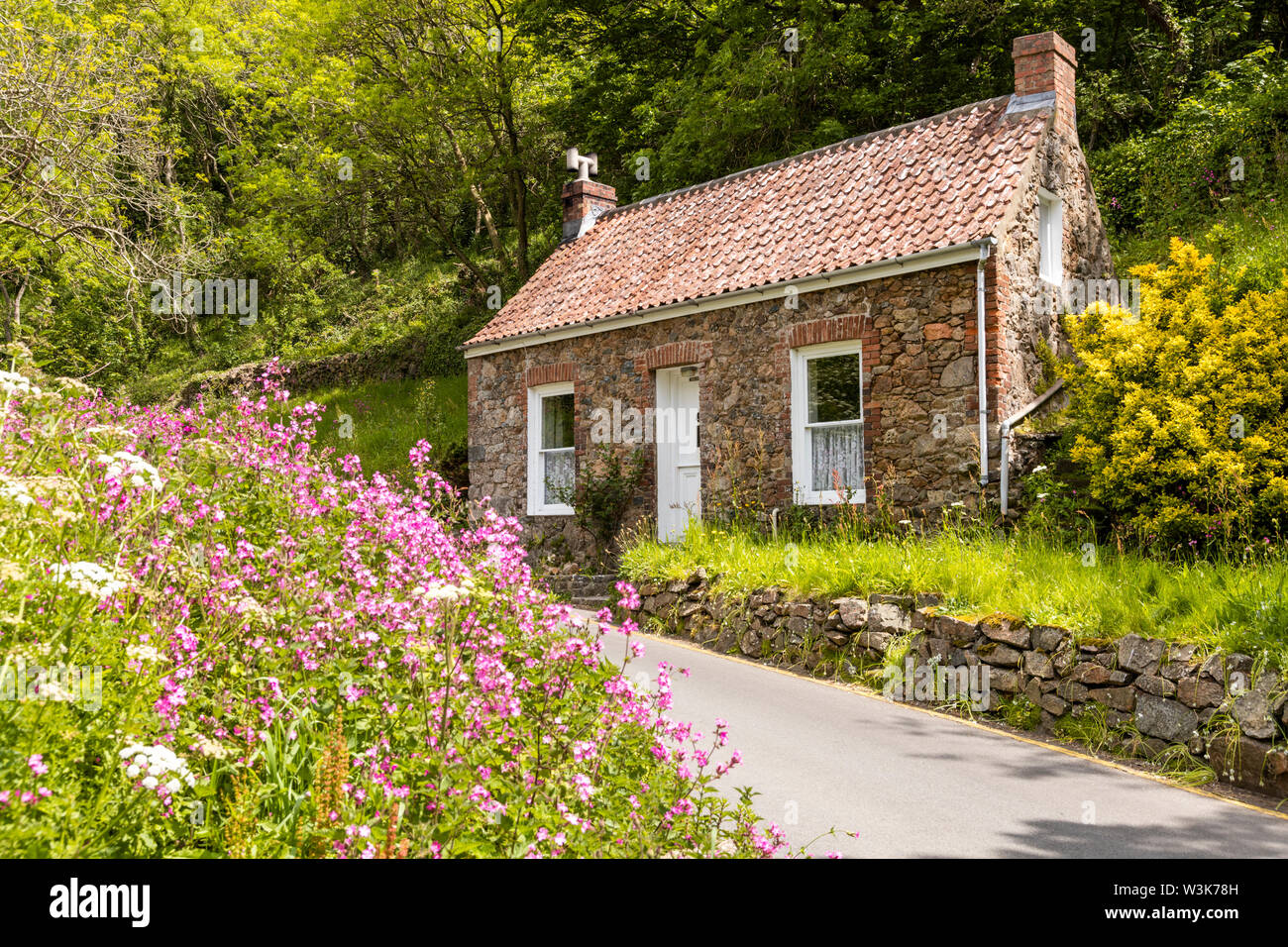 An old stone cottage beside the lane at Petit Bot, Guernsey, UK Stock Photo