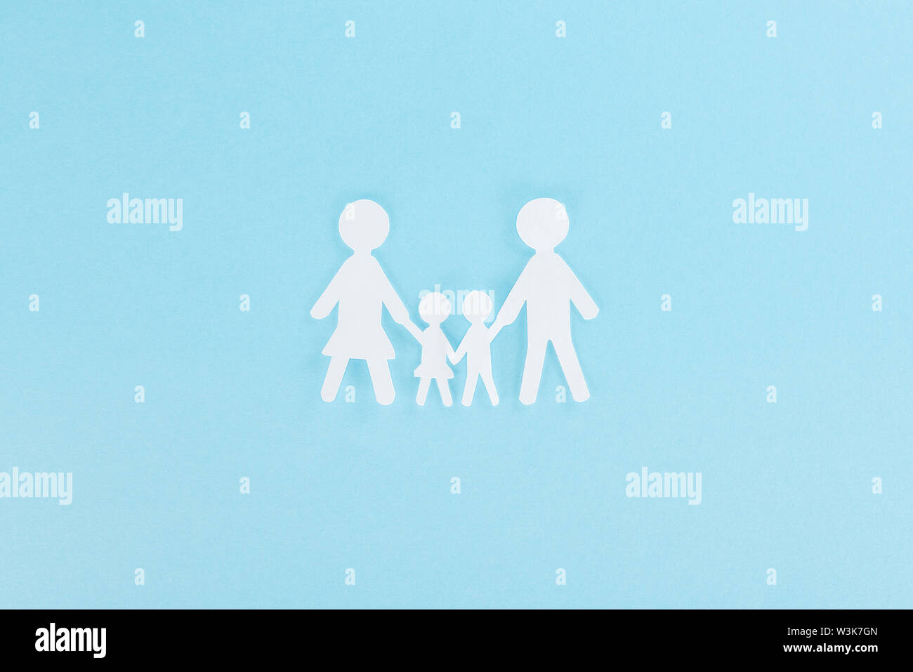 top view of white paper cut family on blue background Stock Photo - Alamy