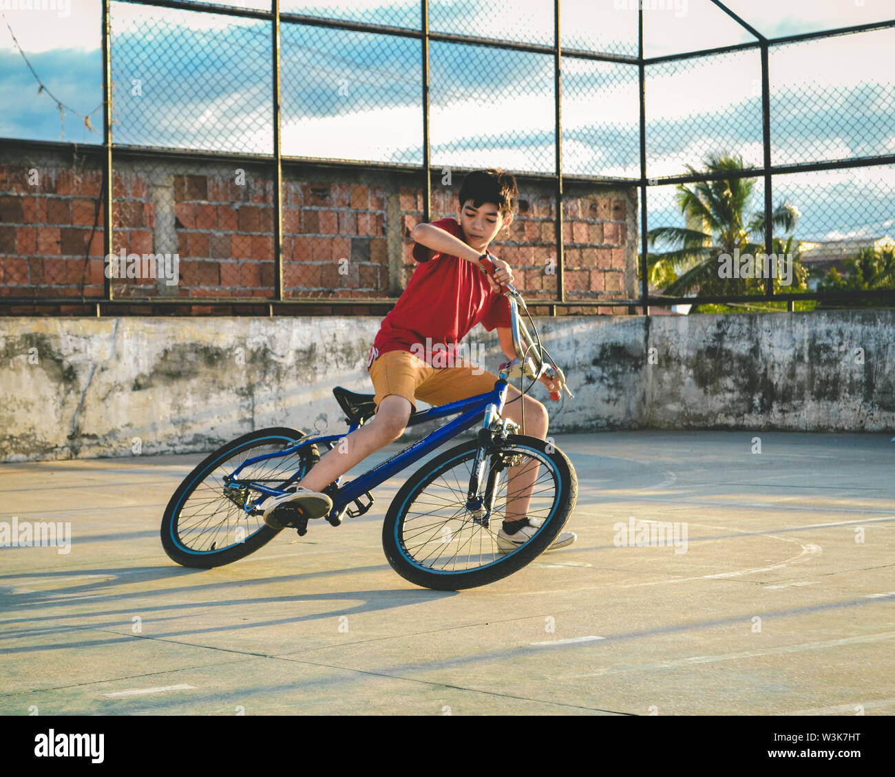 A 12 years old kid doing some tricks on his new bicycle! Stock Photo