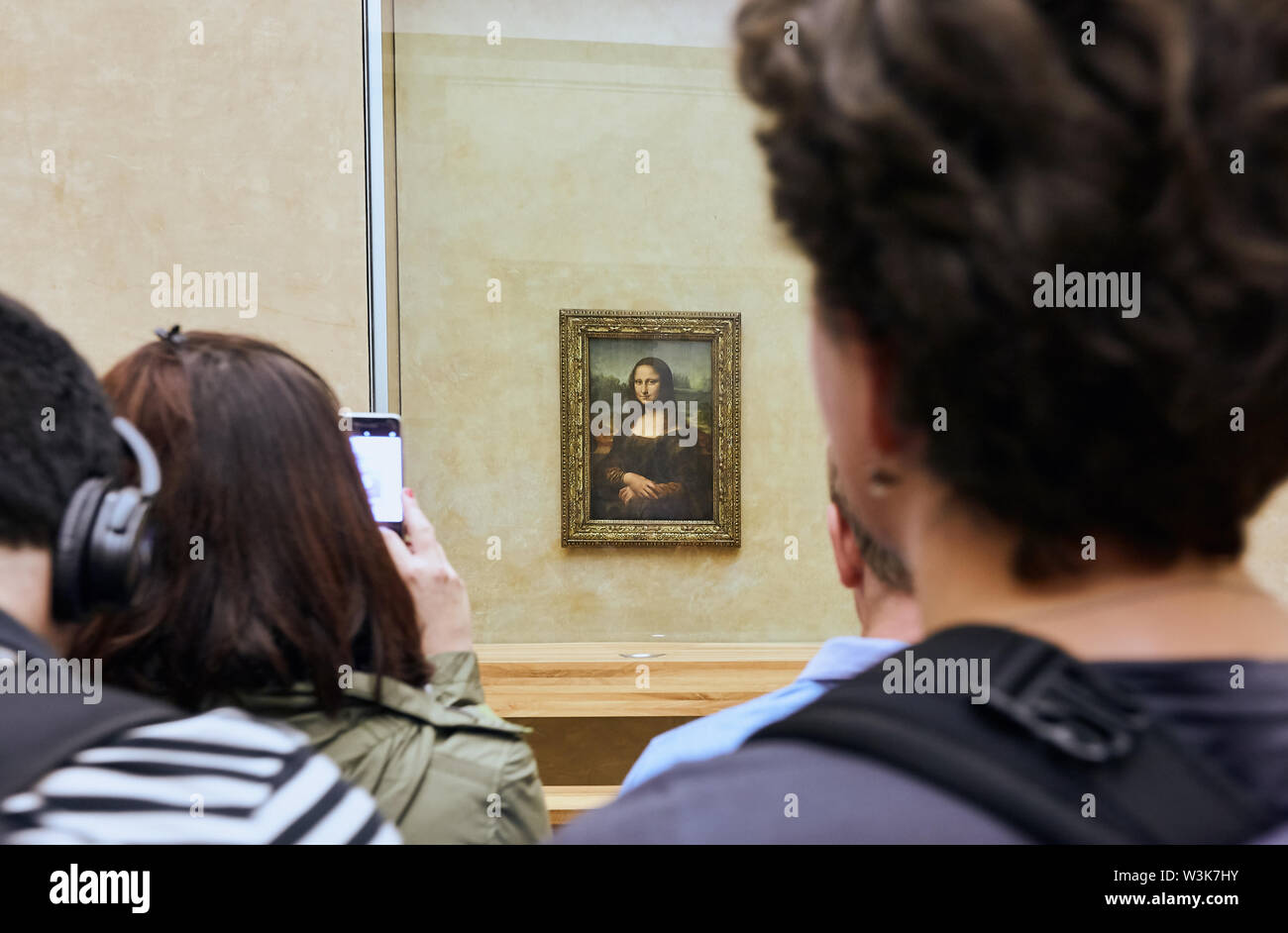 PARIS, FRANCE - October 25, 2017: Visitors take photo of Leonardo DaVinci's Mona Lisa at the Louvre Museum Stock Photo