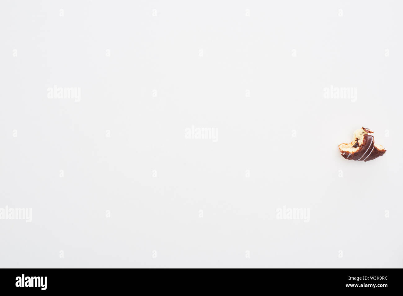 top view of chocolate bitten doughnut on white background Stock Photo ...
