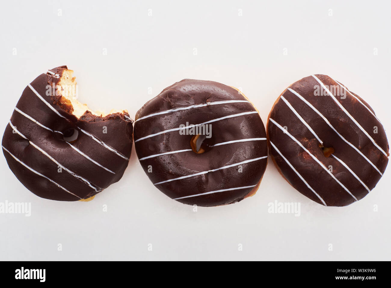 top view of chocolate tasty glazed doughnuts on white background Stock ...