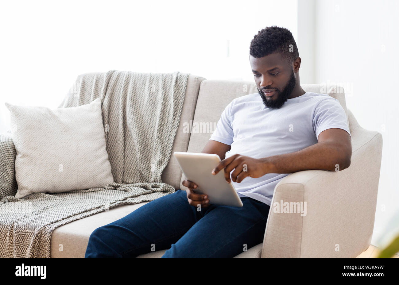 Young african american man using digital tablet Stock Photo