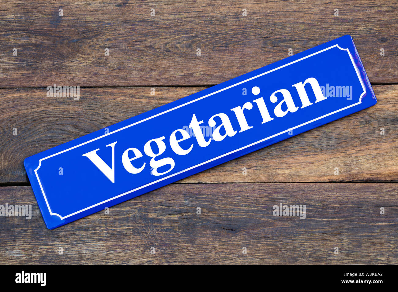 Vegetarian street sign on wooden background as symbol for meatless nutrition Stock Photo