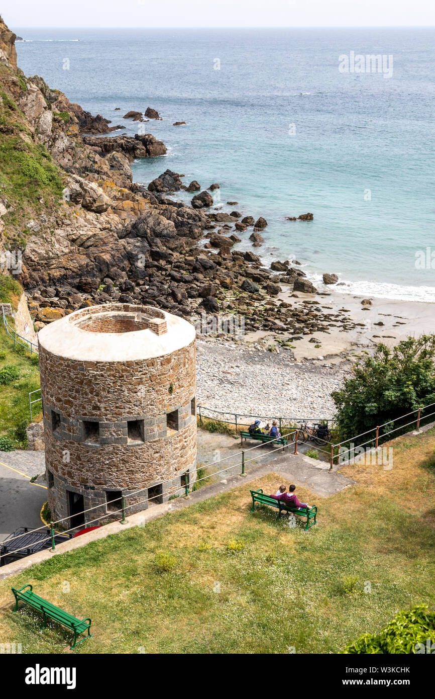 Looking down from the coastal path onto the Napoleonic loophole tower overlooking Petit Bot Bay on the beautiful rugged south coast of Guernsey, Chann Stock Photo