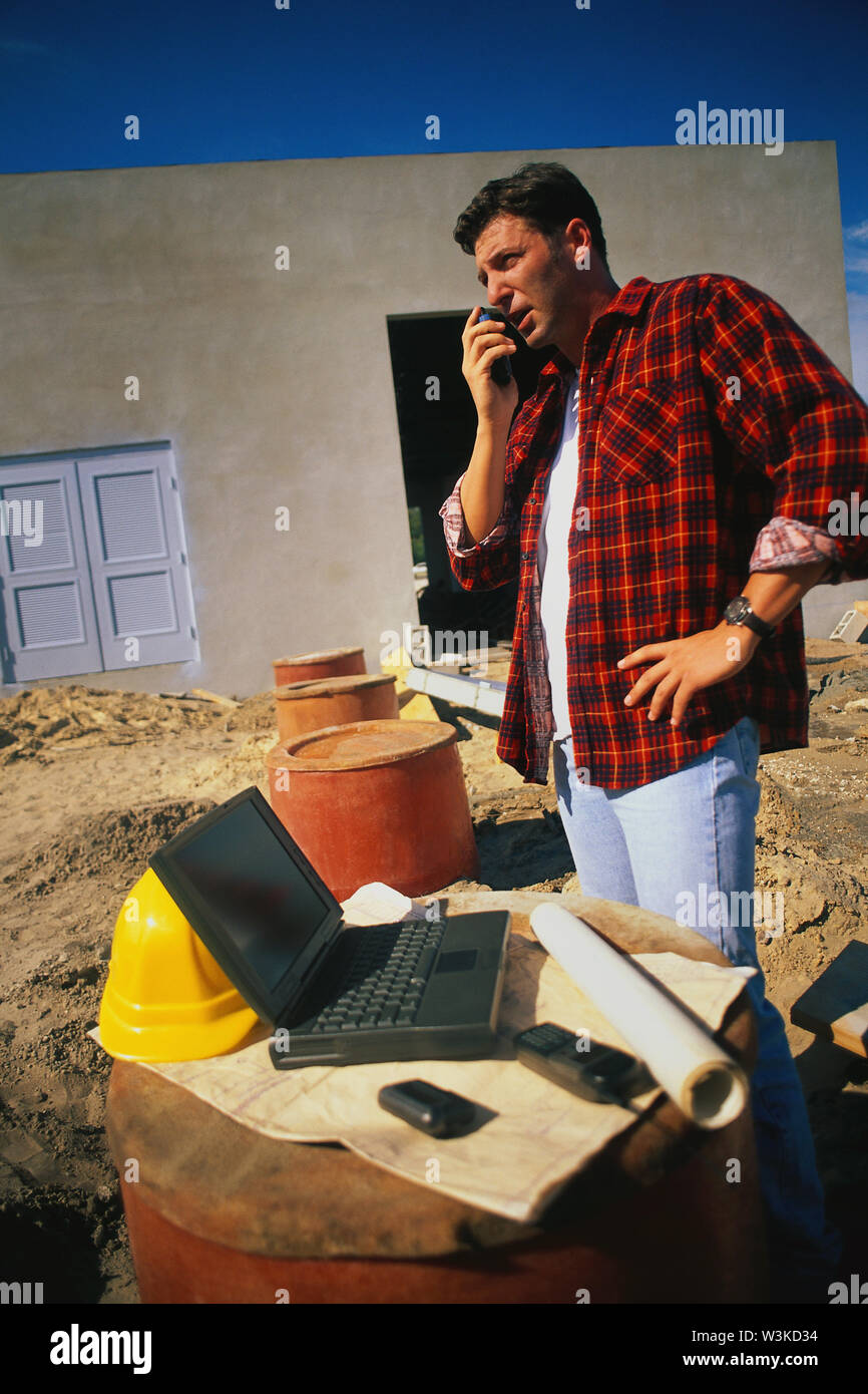 Construction worker  on his phone Stock Photo