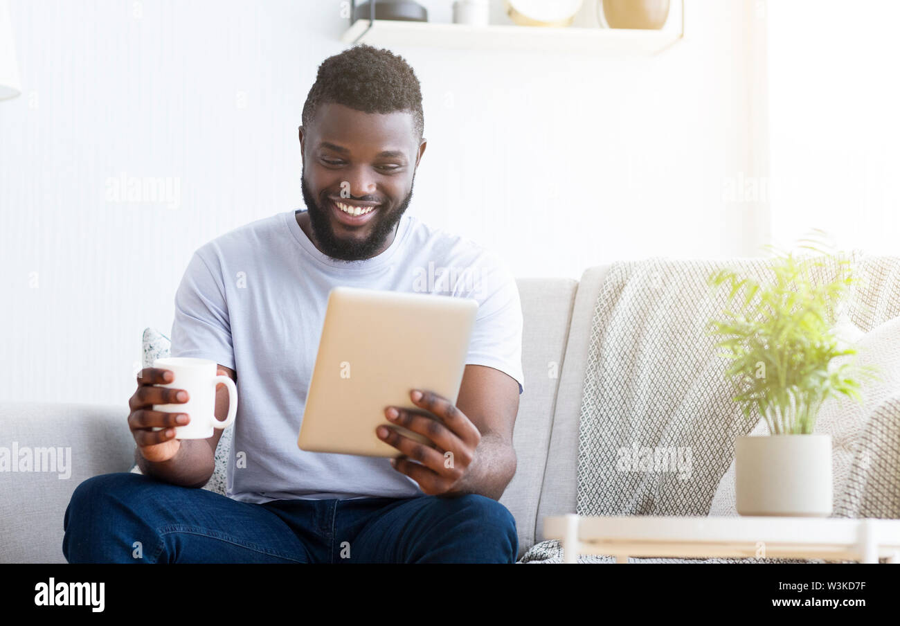 Young man using tablet, having video chat Stock Photo