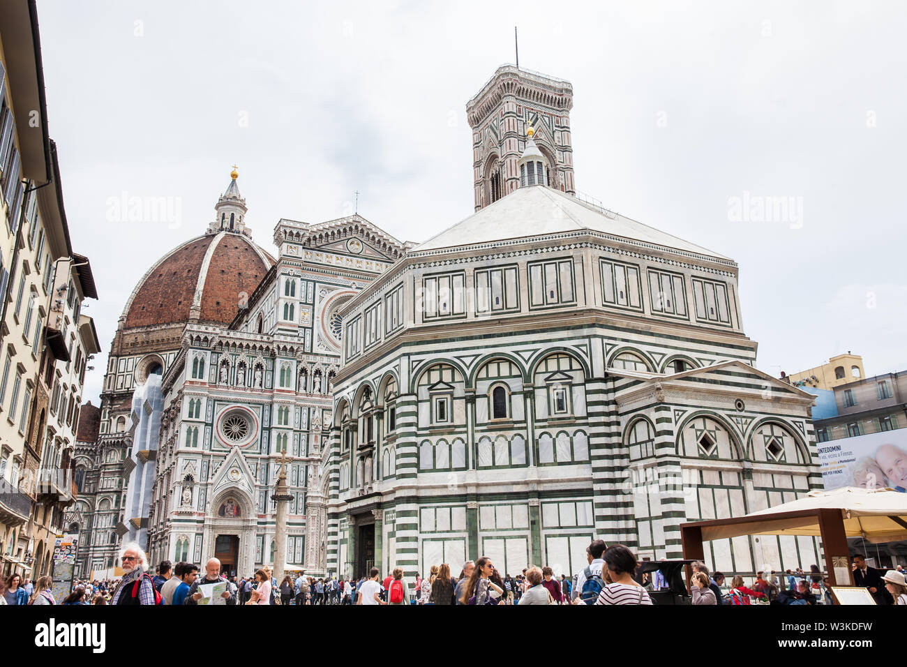 FLORENCE, ITALY - APRIL, 2018: Tourists visiting the historycal Baptistery of St. John, Giotto Campanile and Florence Cathedral consecrated in 1436 Stock Photo