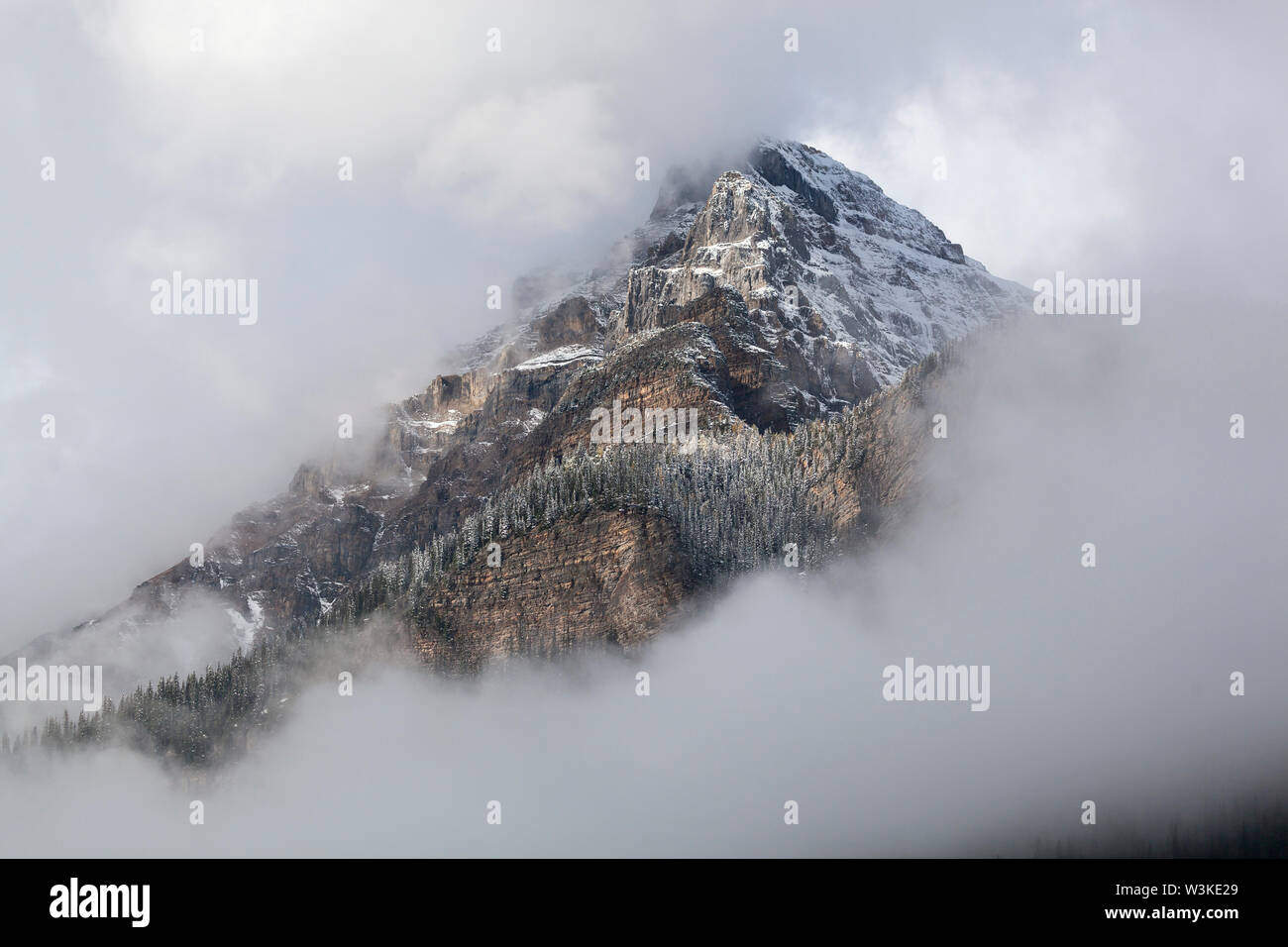 Mountain peak in white clouds Stock Photo