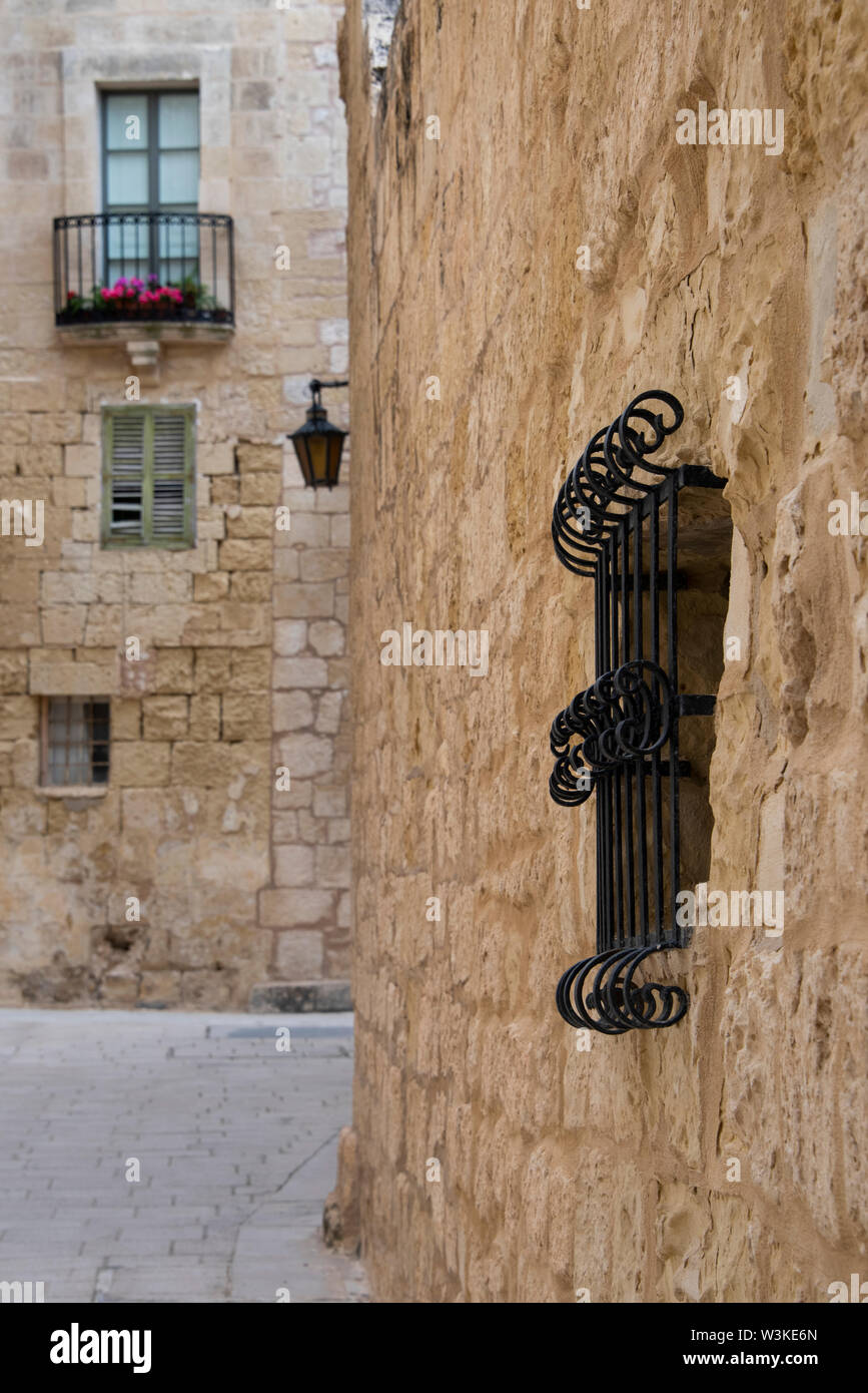 Europe, Malta, Mdina. Typical historic narrow street lined with limestone buildings. Stock Photo