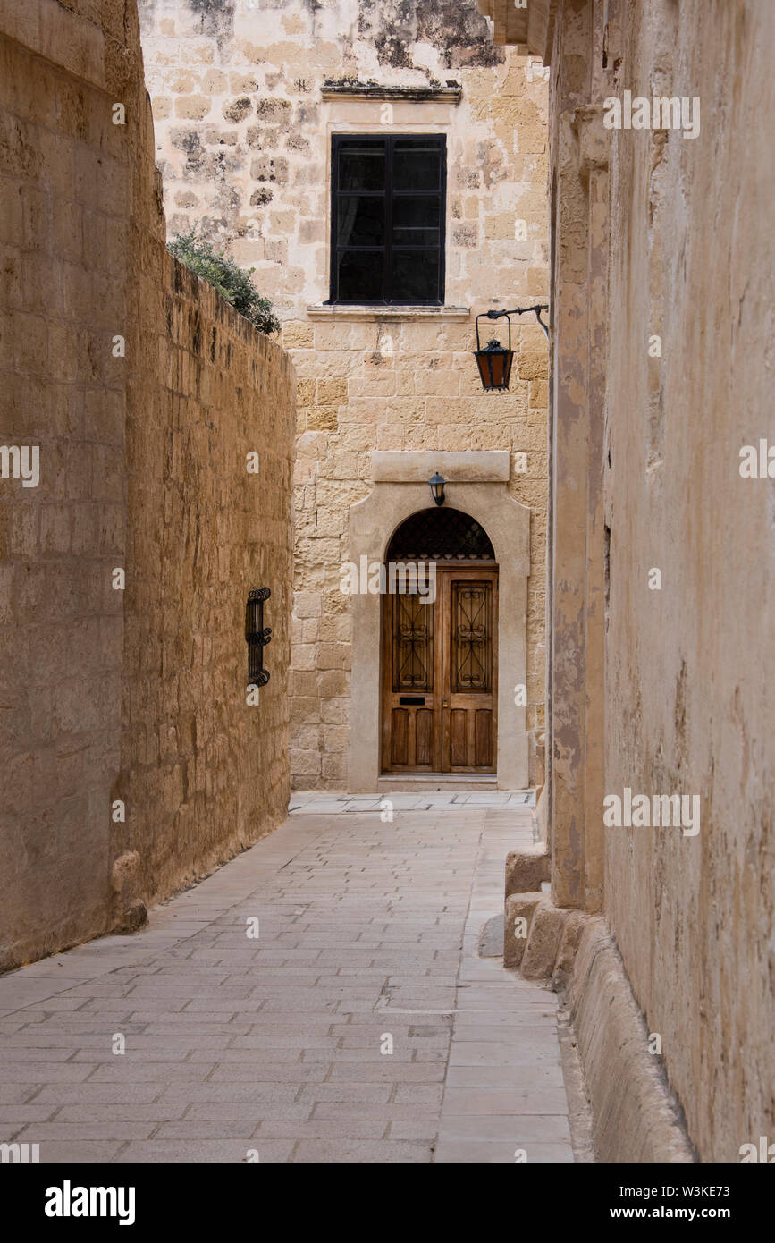 Europe, Malta, Mdina. Typical historic narrow street lined with limestone buildings. Stock Photo