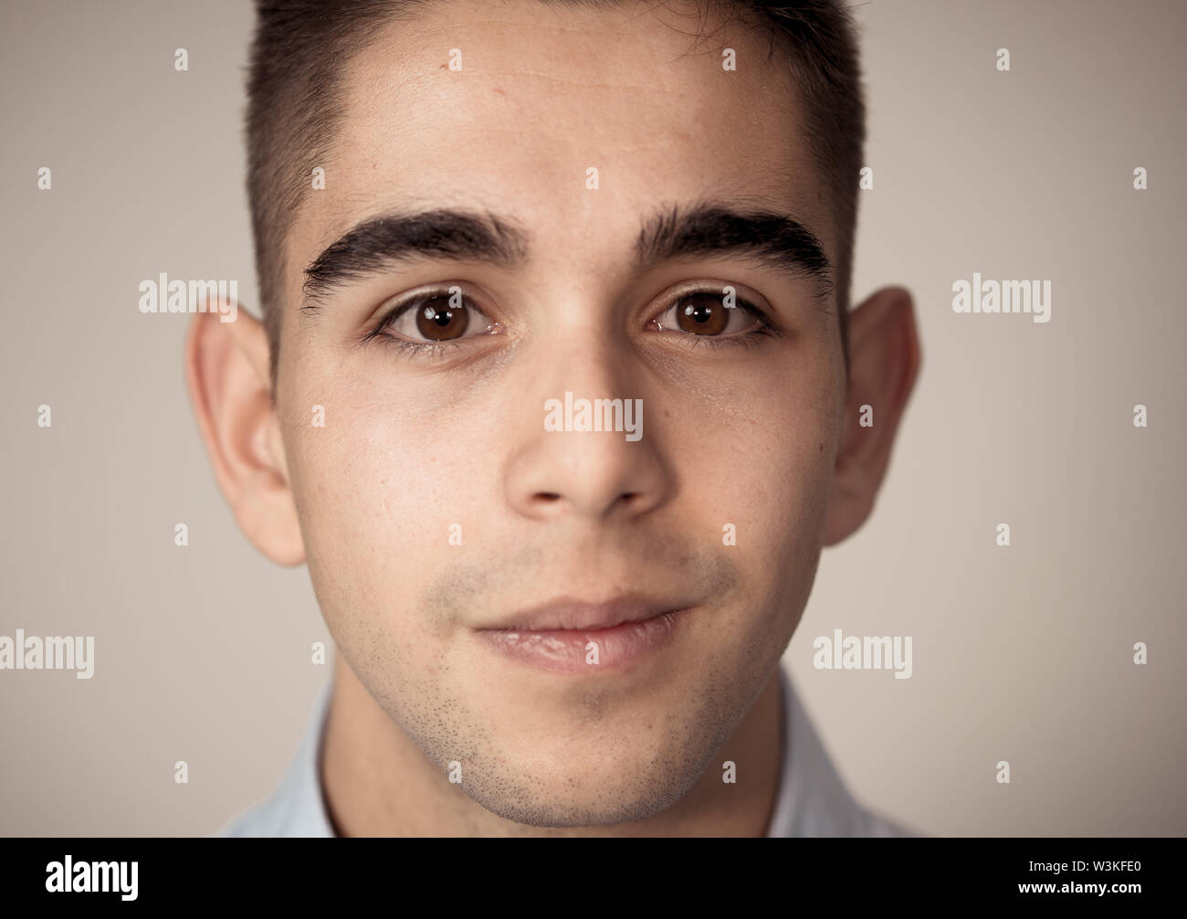 Close up portrait of attractive, confident young man looking neutral