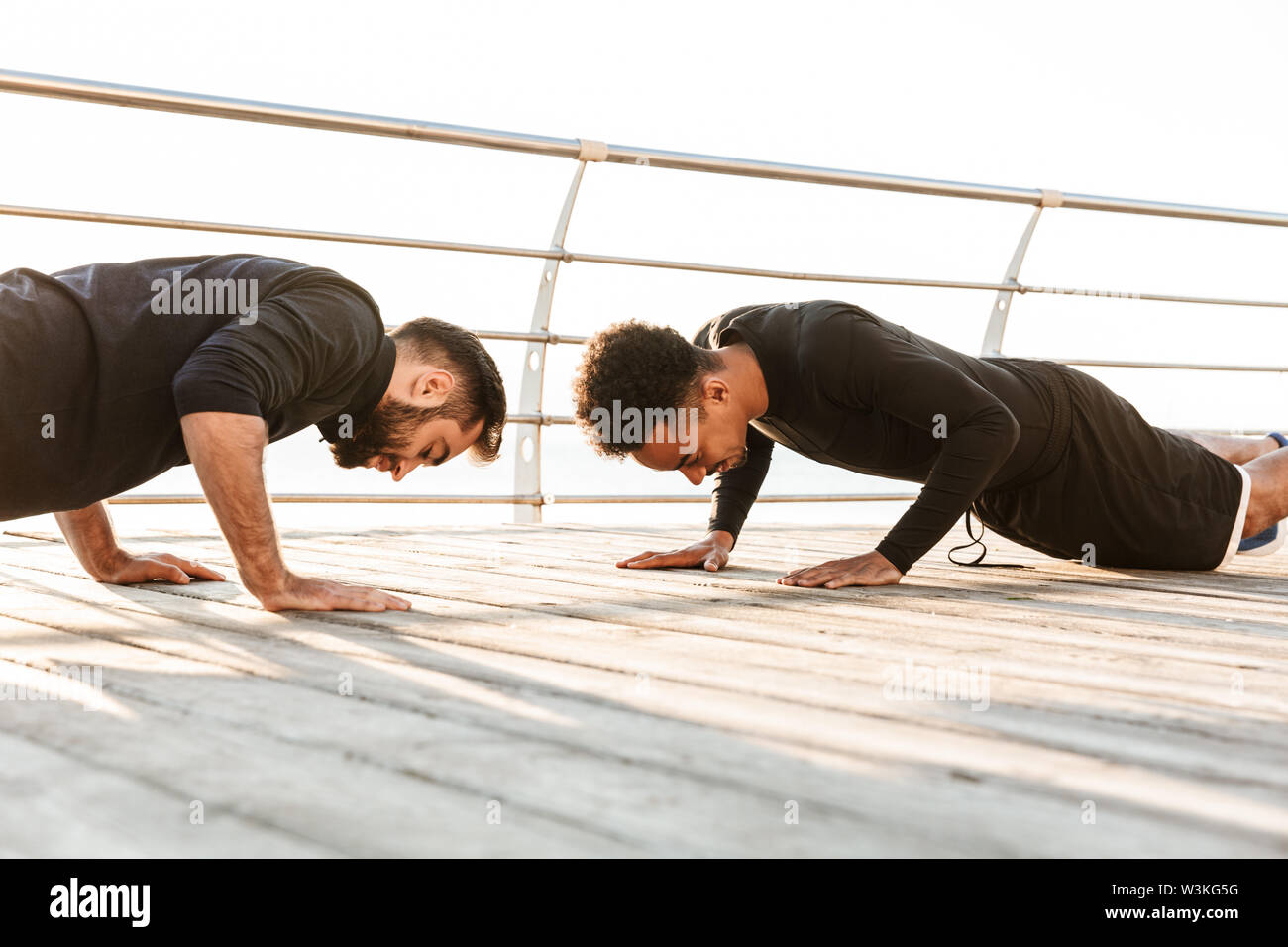 Two Attractive Confident Young Healthy Sportsmen Outdoors At The Beach Workout Together Doing Push Ups Stock Photo Alamy Two Attractive Confident Young Healthy Sportsmen Outdoors At The Beach Workout Together Doing Push Ups Stock Photo Alamy