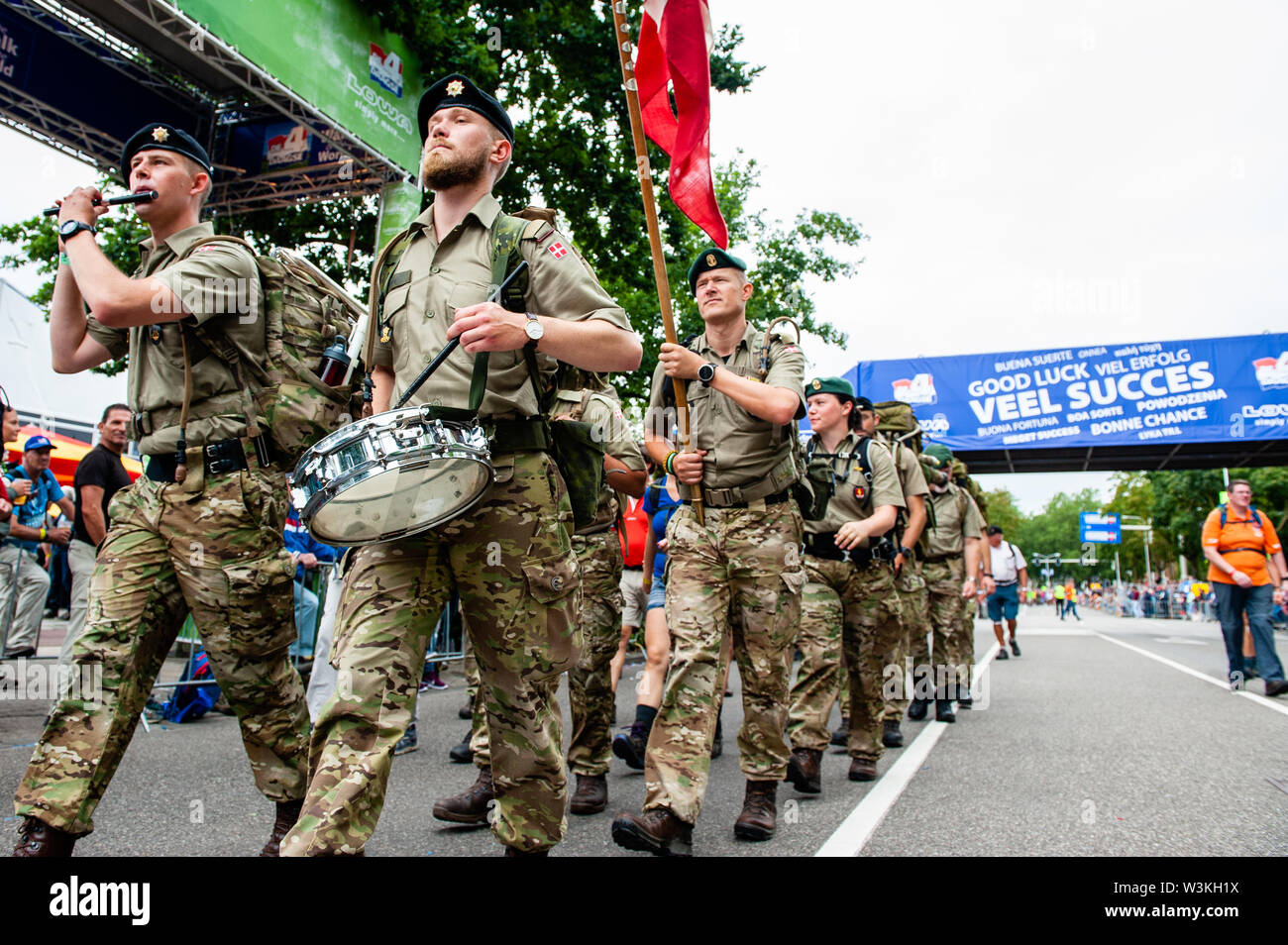 A Group Of Soldiers Cross The Finish Line While Playing Instruments During The First Day Since It Is The World S Biggest Multi Day Walking Event The Four Days March Is Seen As The Prime
