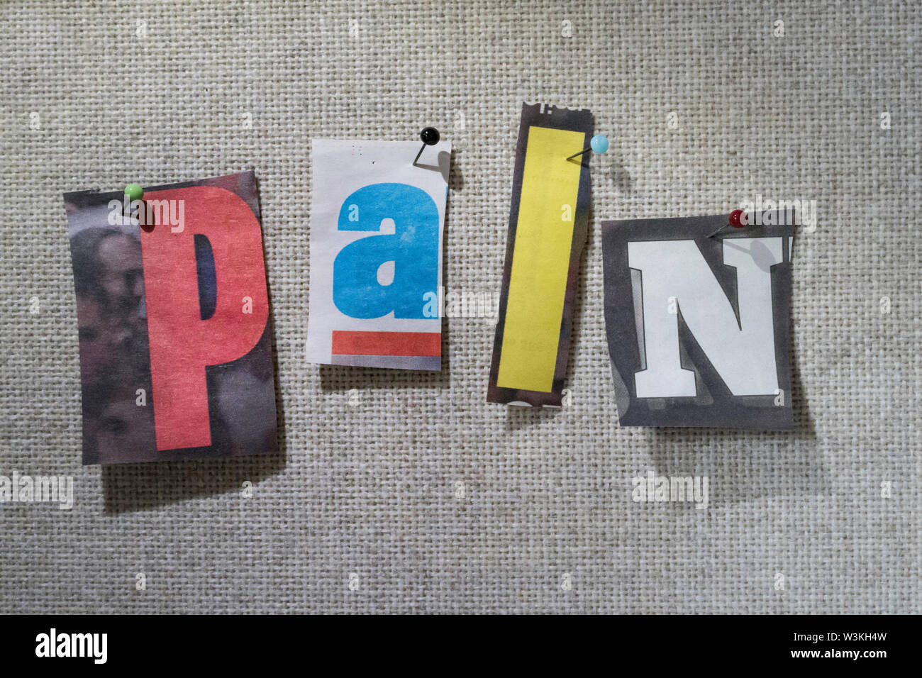 The word Pain on a bulletin board using cutout paper letters in the