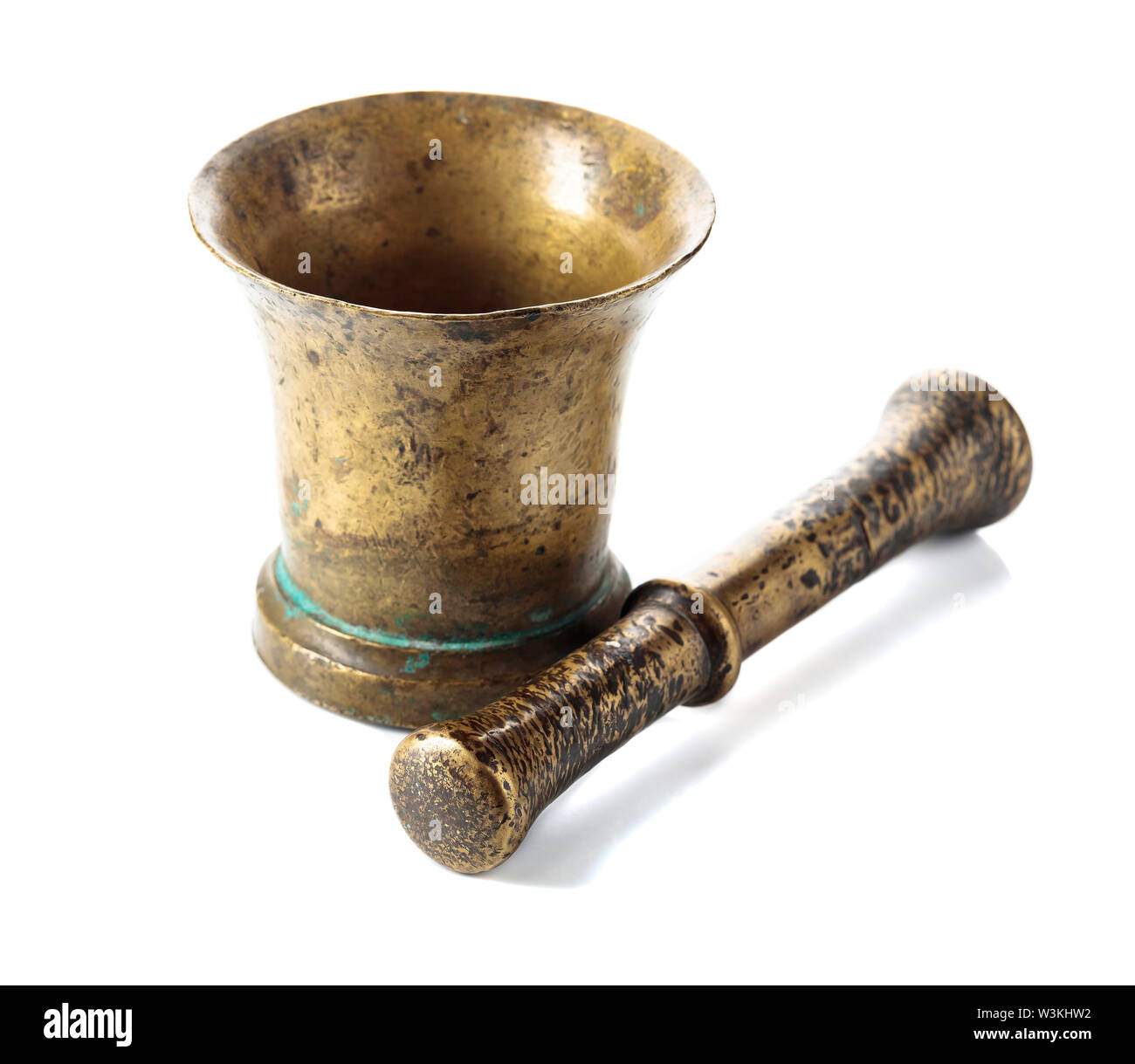 Vintage brass mortar and pestle isolated on a white background Stock
