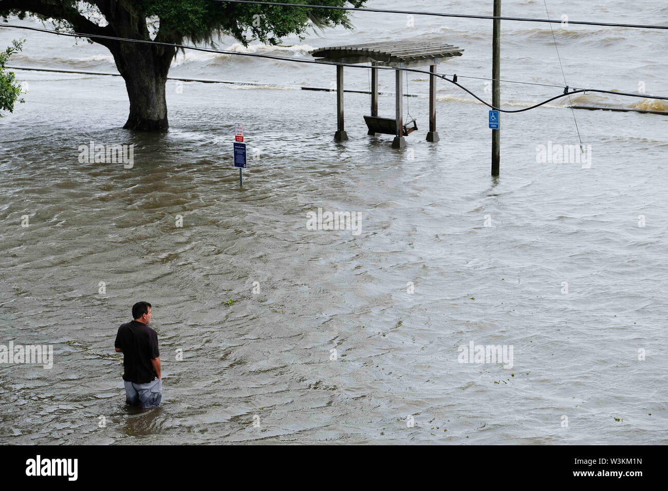 July 13, 2019 - Mandeville, LOUISIANA, U.S - Chris Ladner looks out at a flooded area next to Lake Pontchartrain in Mandeville, Louisiana USA as Hurricane Barry makes landfall on July 13, 2019. (Credit Image: © Dan Anderson/ZUMA Wire) Stock Photo