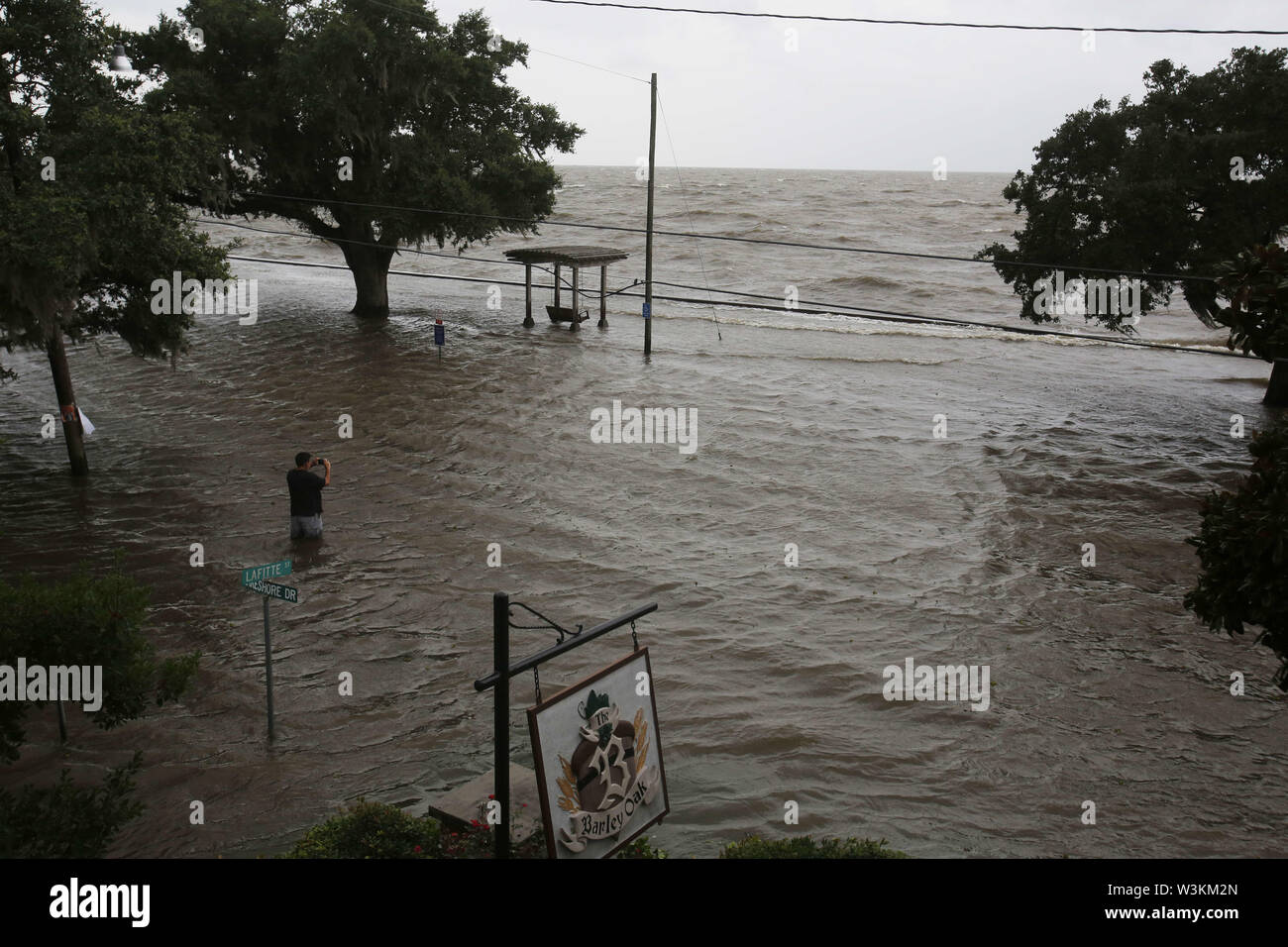 July 13, 2019 - Mandeville, LOUISIANA, U.S - Chris Ladner looks out at a flooded area next to Lake Pontchartrain in Mandeville, Louisiana USA as Hurricane Barry makes landfall on July 13, 2019. (Credit Image: © Dan Anderson/ZUMA Wire) Stock Photo