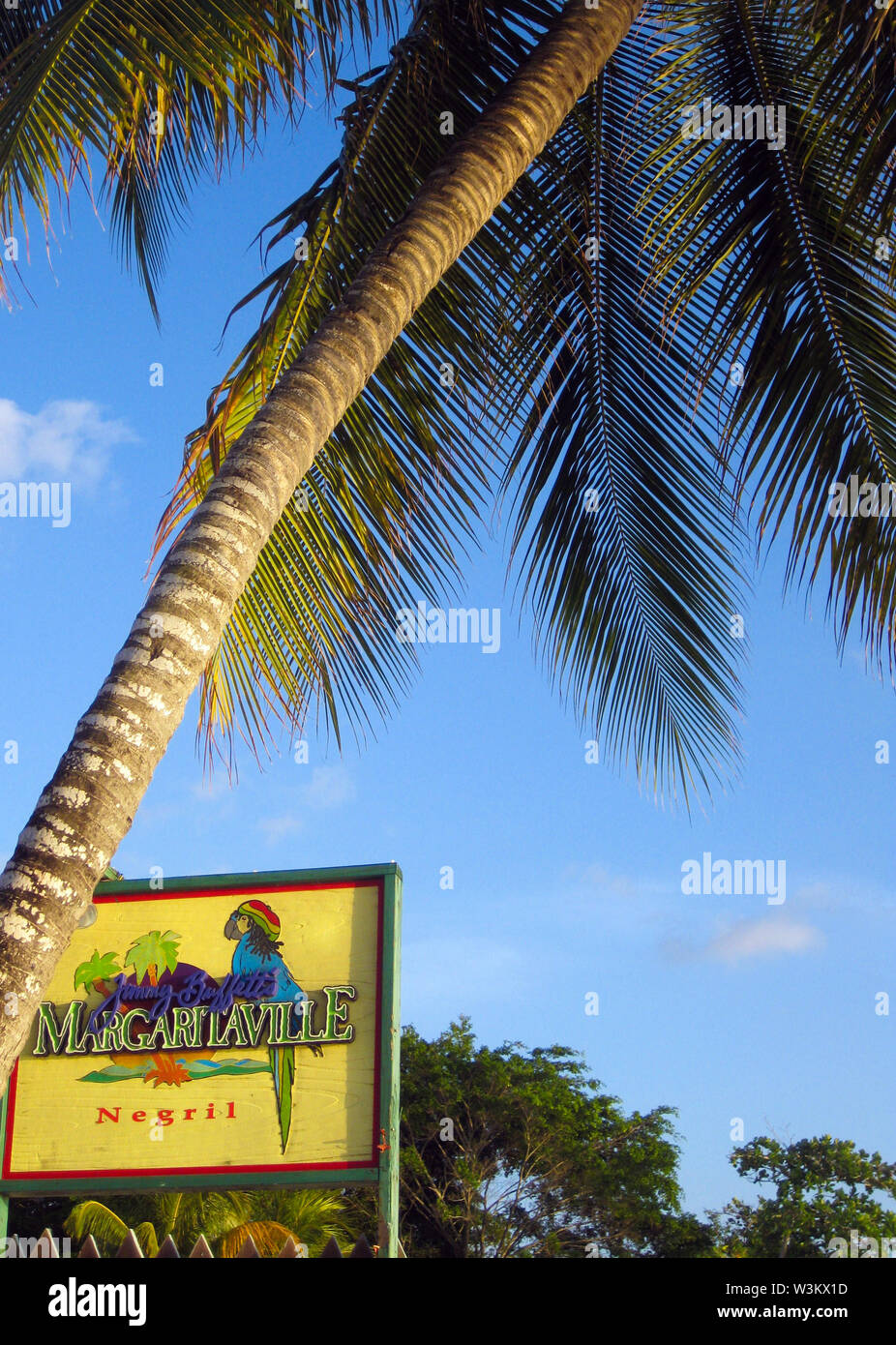 NEGRIL, JAMAICA - MAY 24. 2010: Margaritaville sign with palm tree on Bourbon beach Stock Photo