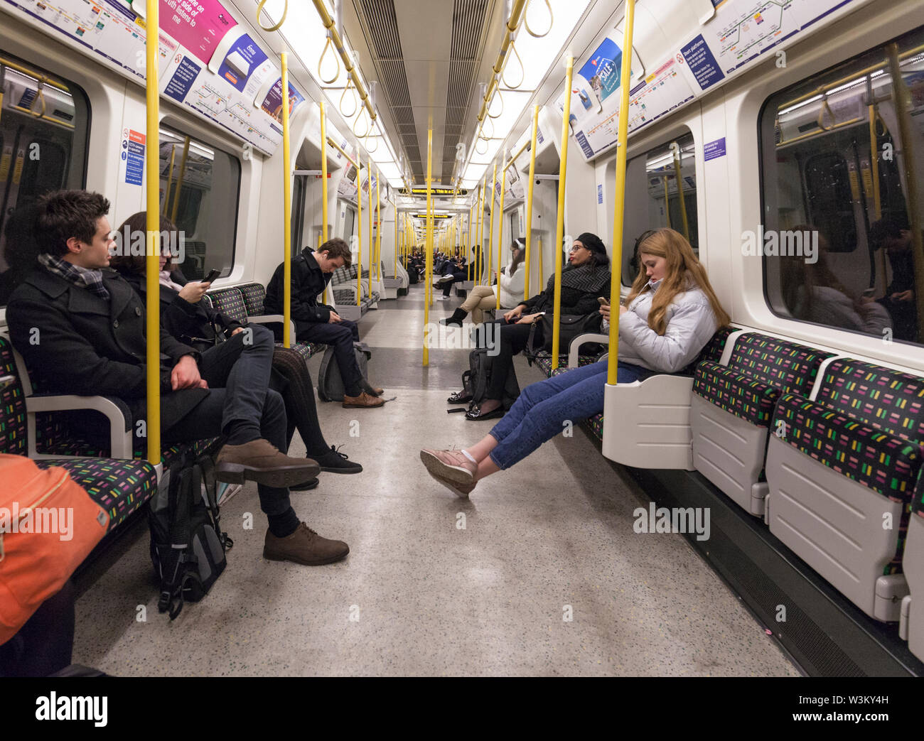 Passengers on a London underground / London Tube district line train Stock Photo