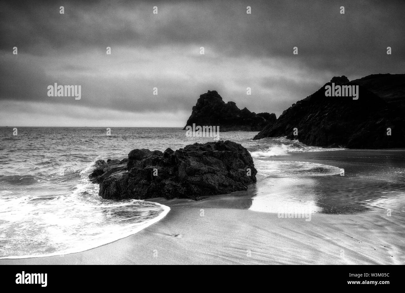 Monochrome of the beach at Low Tide, Kynance Cove in Cornwall, England UK Stock Photo