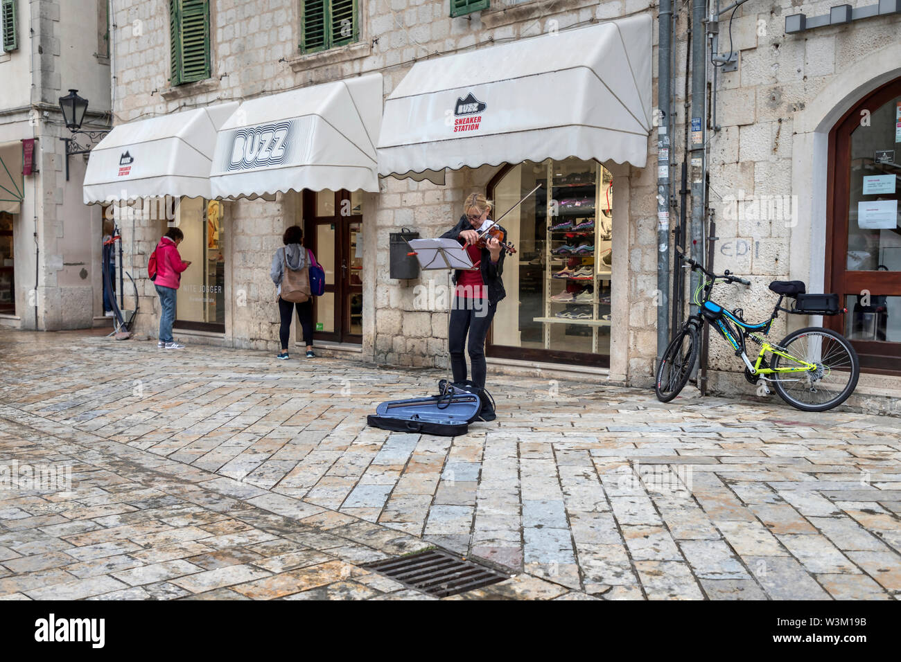 Montenegro, April 30th 2019: A woman violinist busking in the Old Town of Kotor Stock Photo