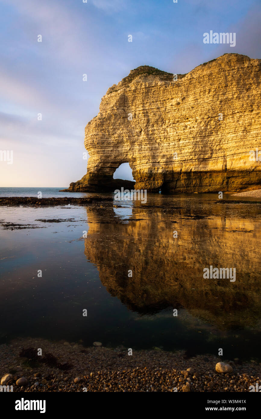 Beautiful and scenic landscape of the Falaise d'Amont at dusk or sunset, famous cliff of the Normandy Coast, Etretat, France. Stock Photo