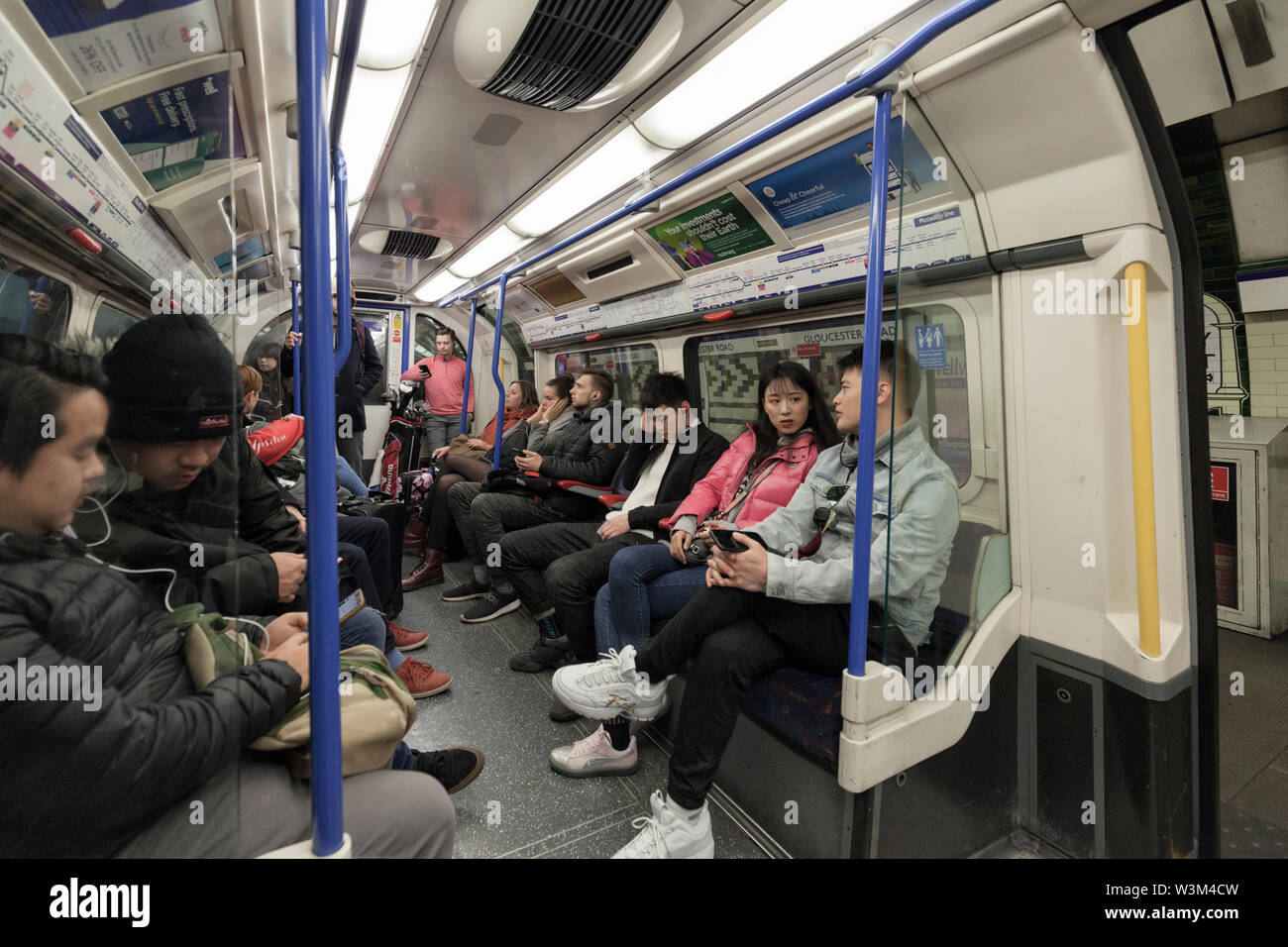 Passengers on a London Underground / London Tube eastbound Piccadilly line underground train heading in to London Stock Photo