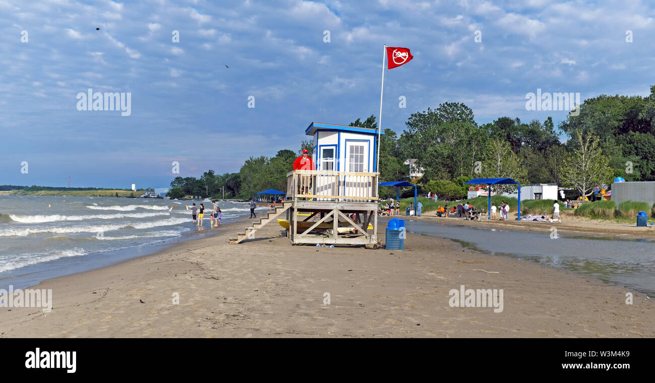 Fairport Harbor Lakefront Park on Lake Erie in Fairport Harbor, Ohio is flooded placing the lifeguard stand on an independent strand of sand. Stock Photo