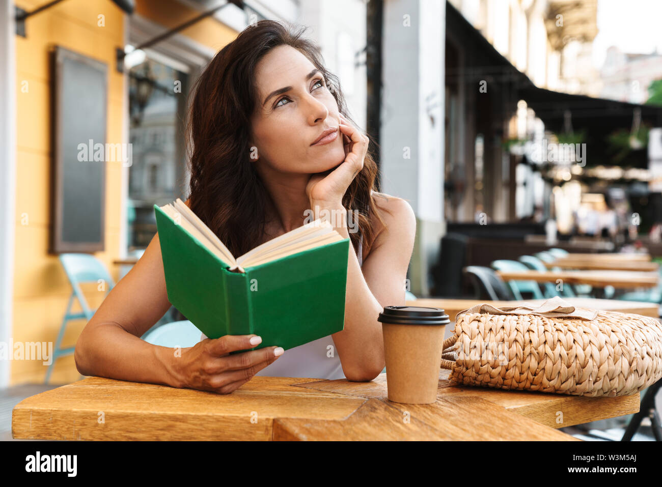 Brooding beautiful girl sitting hi-res stock photography and images - Alamy
