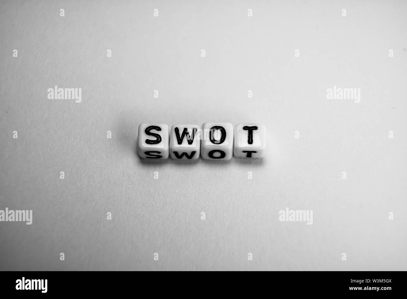 White cubes with word SWOT on white paper background and dark shadows Stock Photo