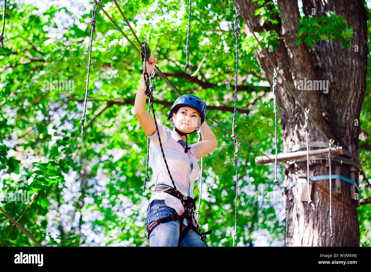 adventure climbing high wire park people on course in mountain helmet