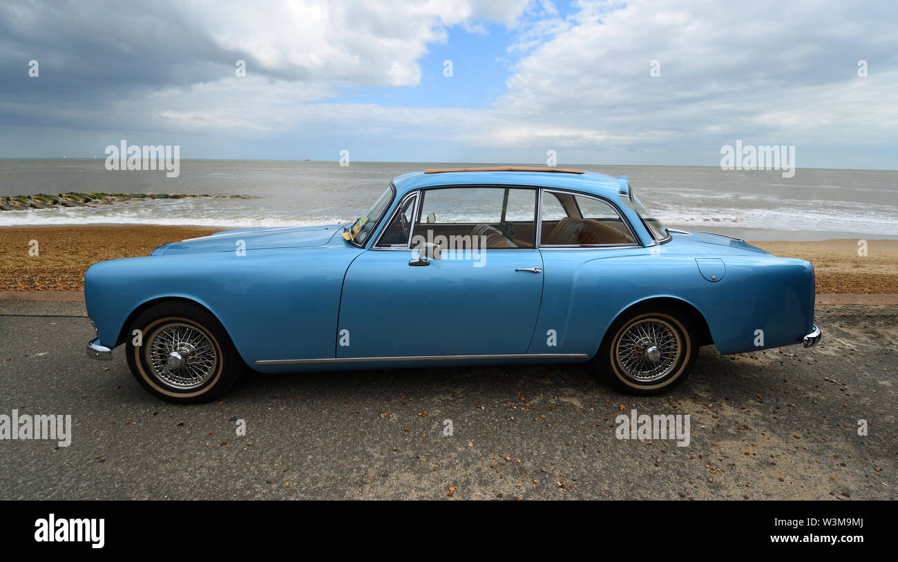 Classic Blue Alvis Motor Car Parked on Seafront Promenade. Stock Photo