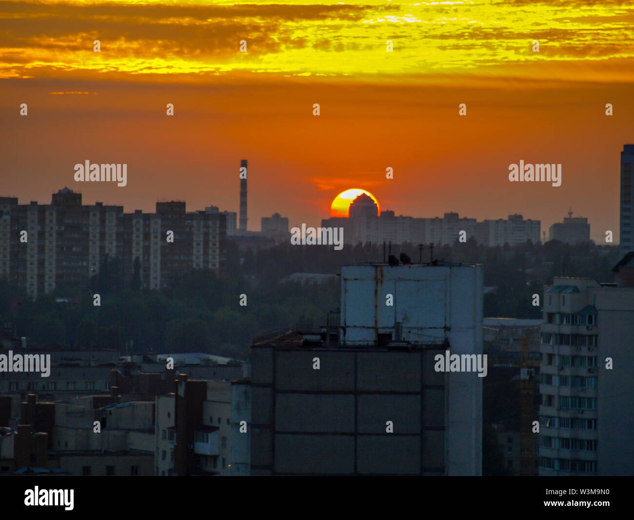 Sun rising over Kyiv city skyline, Ukraine Stock Photo