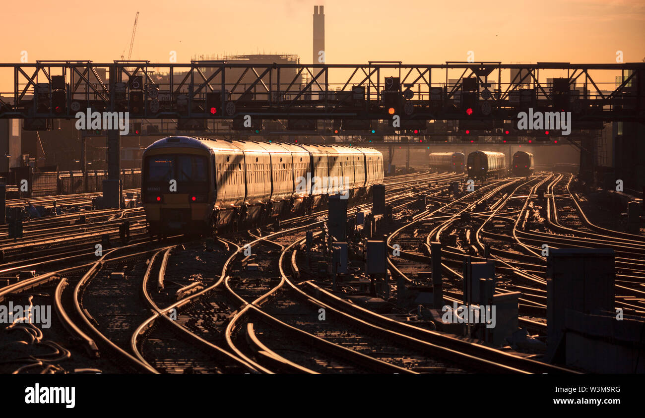 Southeastern  465903 departs from London Bridge glinting in the rising winter sun during the London commuter rush hour Stock Photo