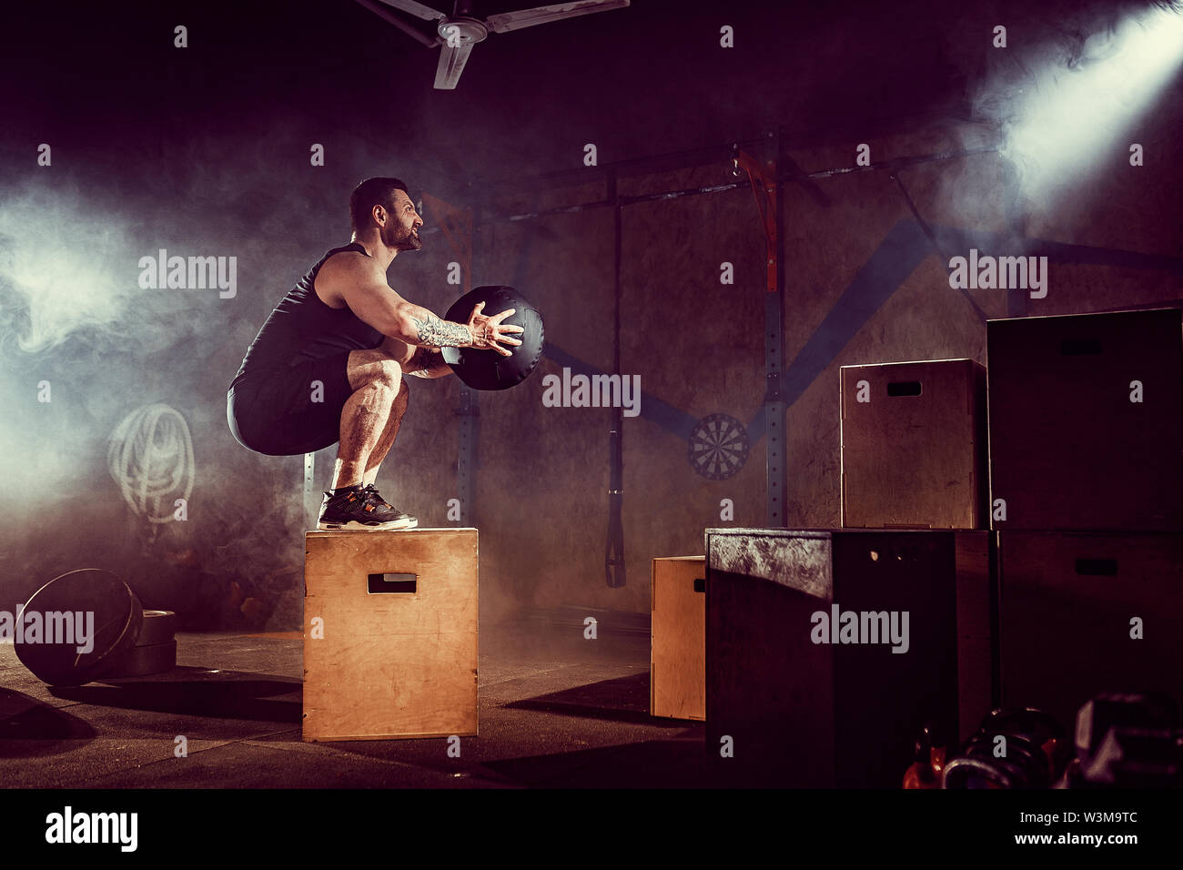Athlete gave exercise. Jumping on the box. Phase touchdown. Gym shots ...