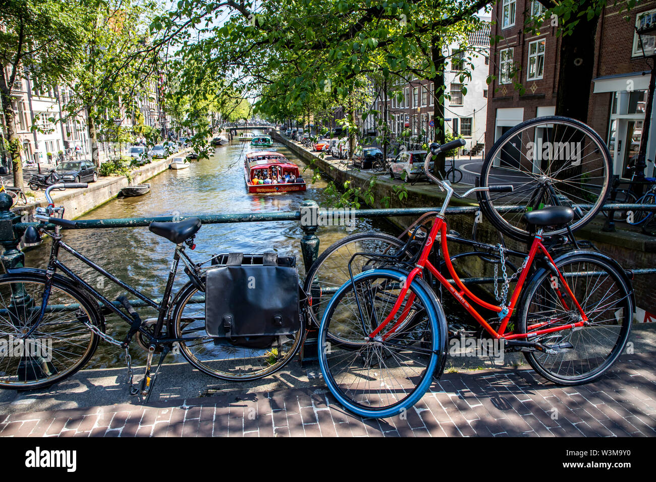 Amsterdam, Netherlands, downtown, old town, wheels, parked on a railing of a bridge over a canal, Stock Photo