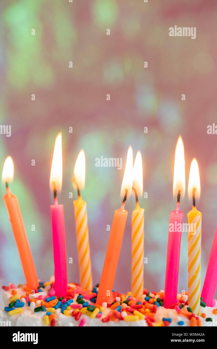 Lit candles on birthday cake Stock Photo - Alamy