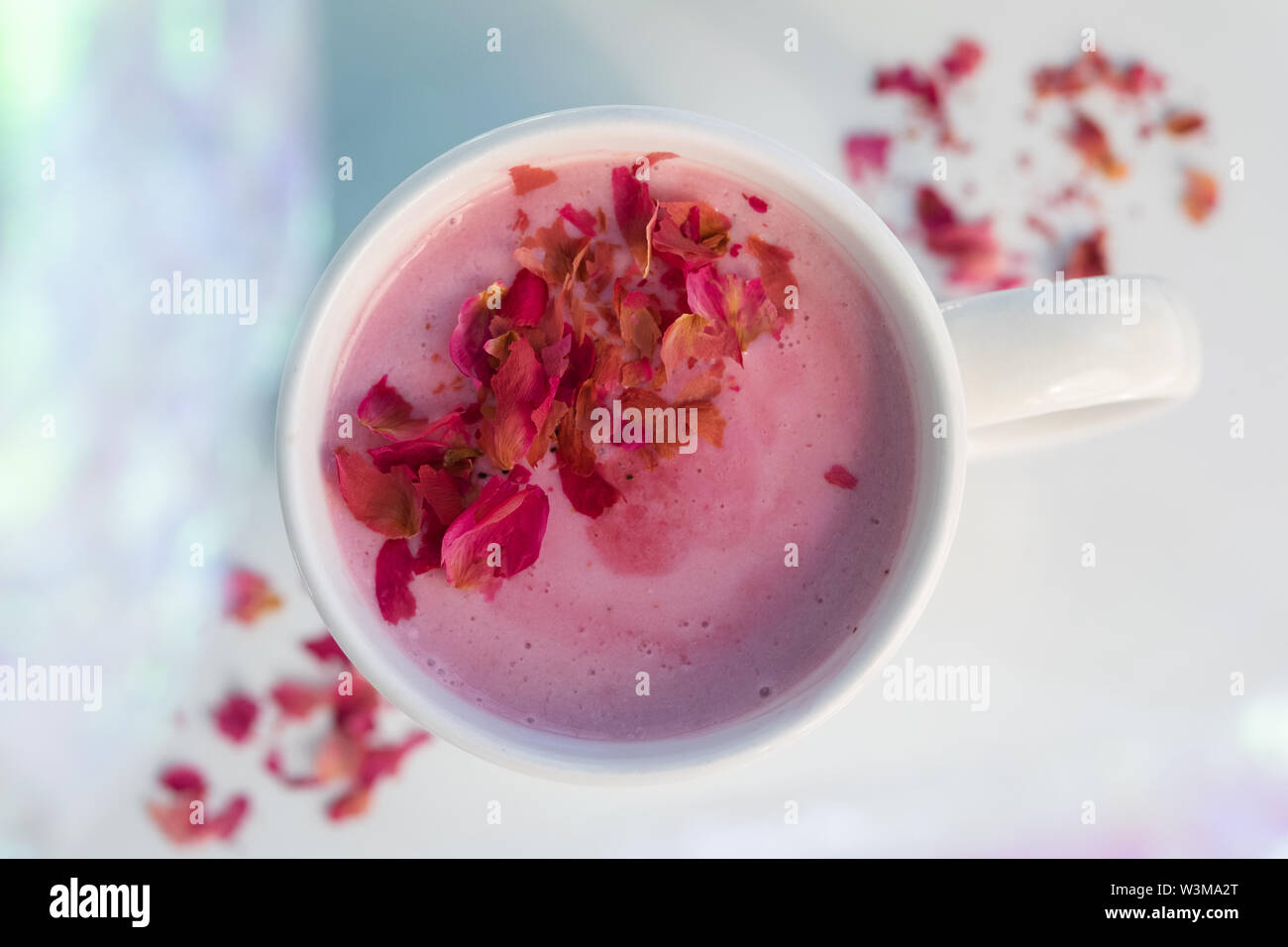 Pink drink topped with petals Stock Photo