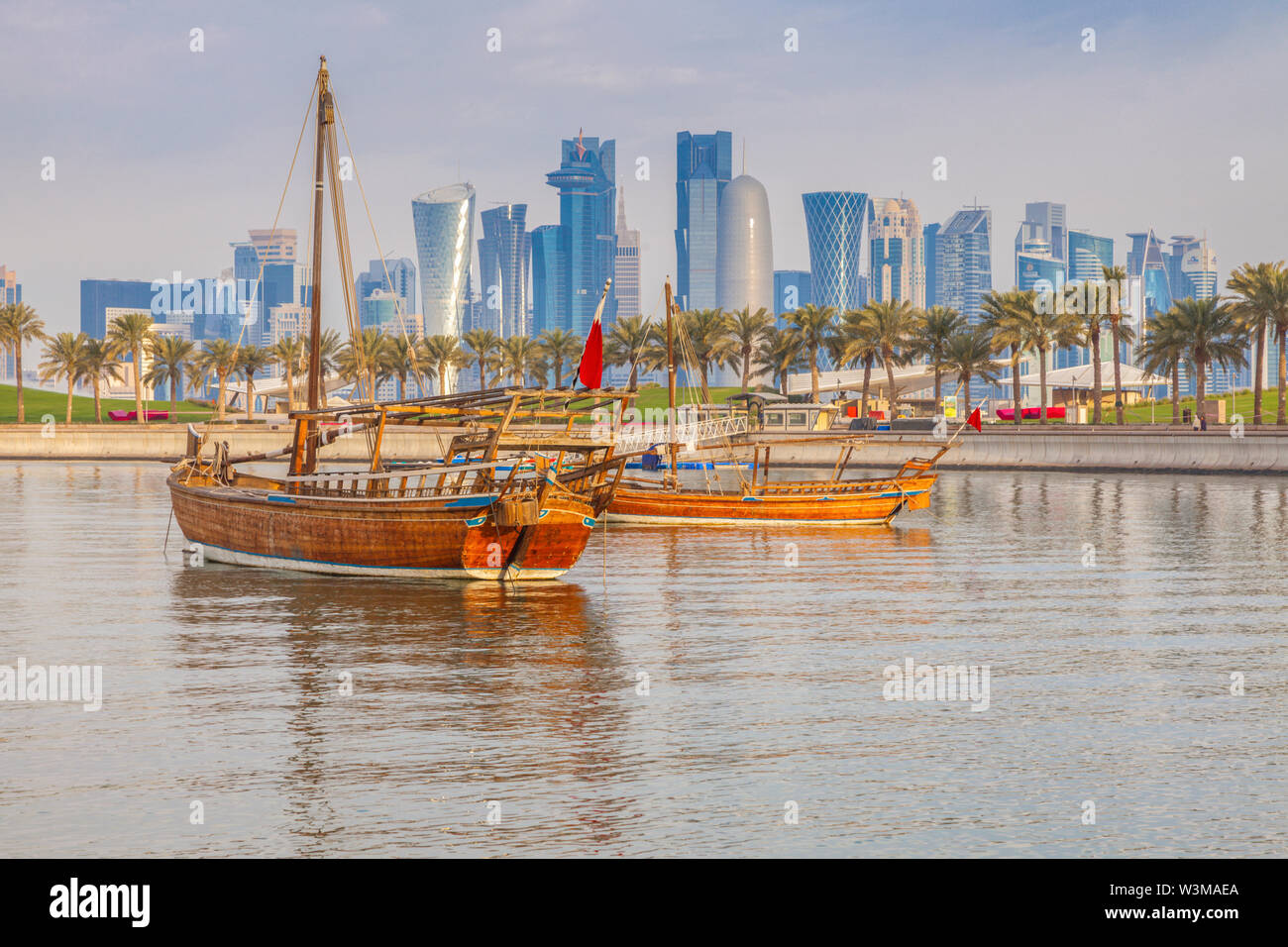 Boats by skyscraper skyline in Doha, Qatar Stock Photo