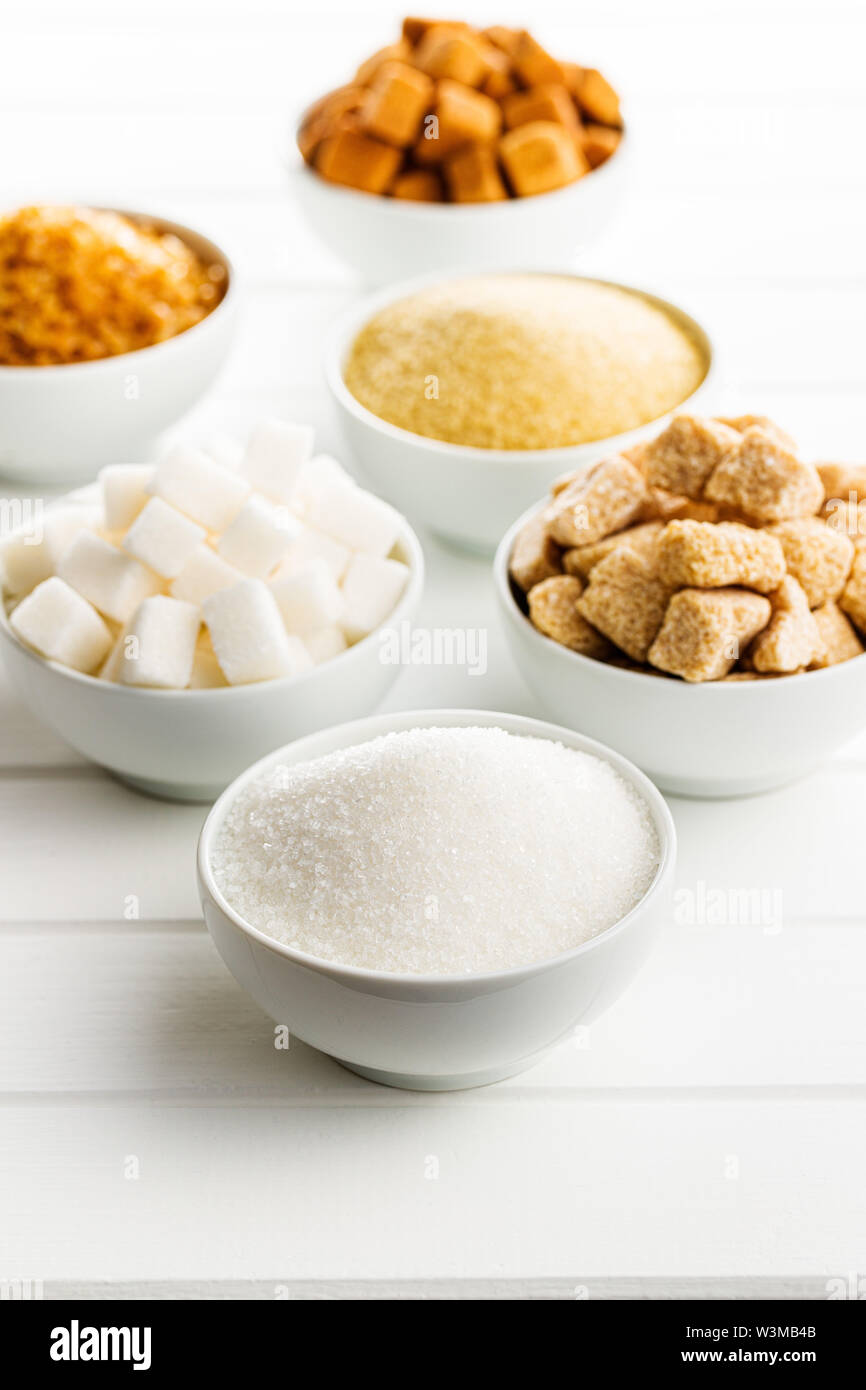 Brown and white sugar on white table. Stock Photo