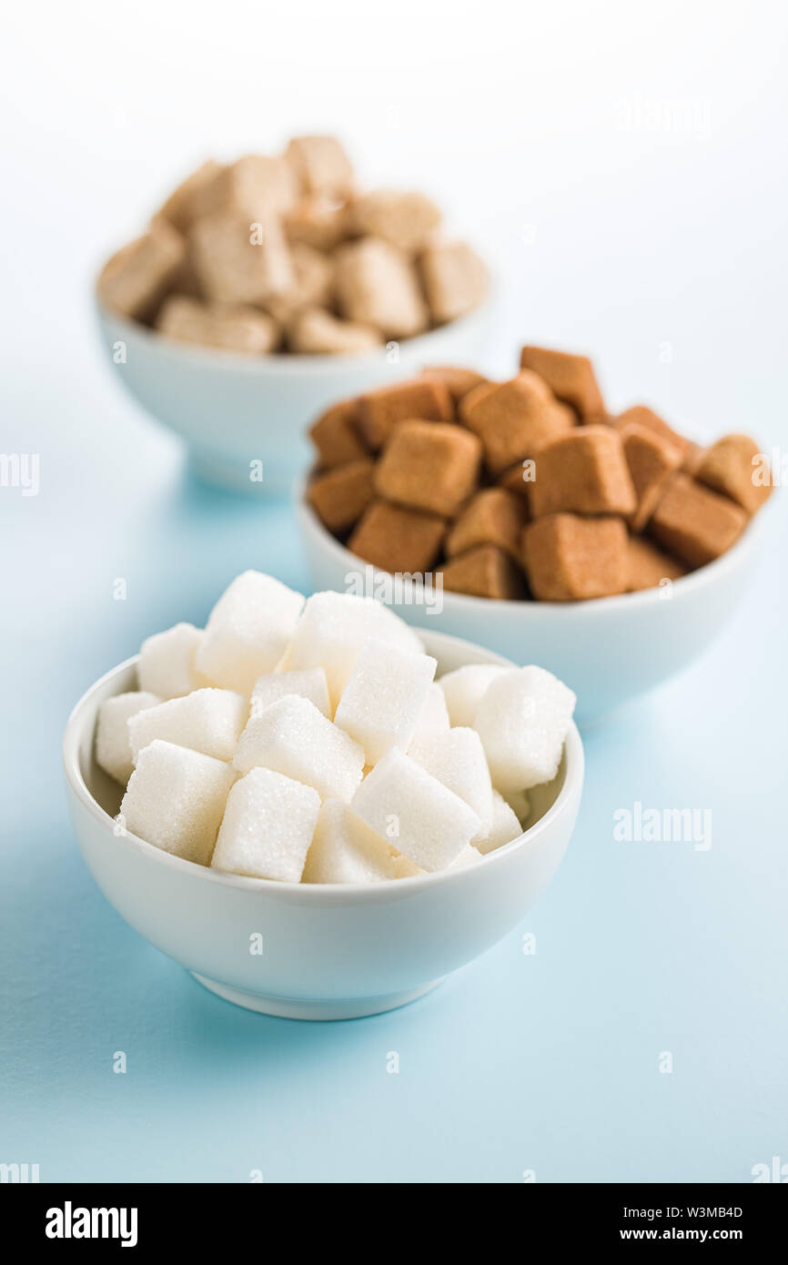 Brown and white sugar on blue table. Stock Photo
