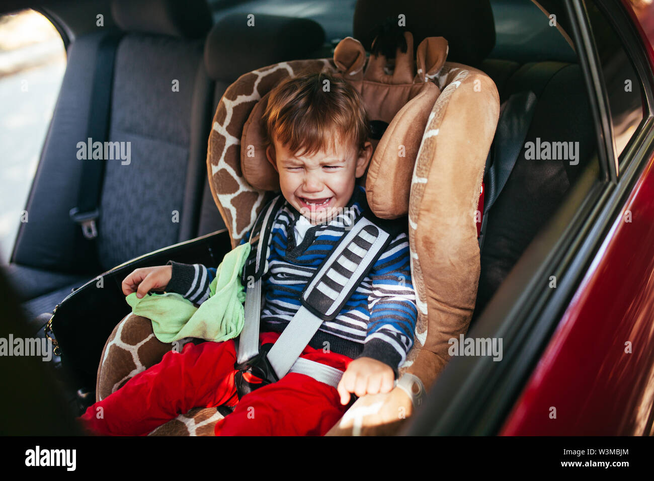 Child crying car seat hi-res stock photography and images - Alamy