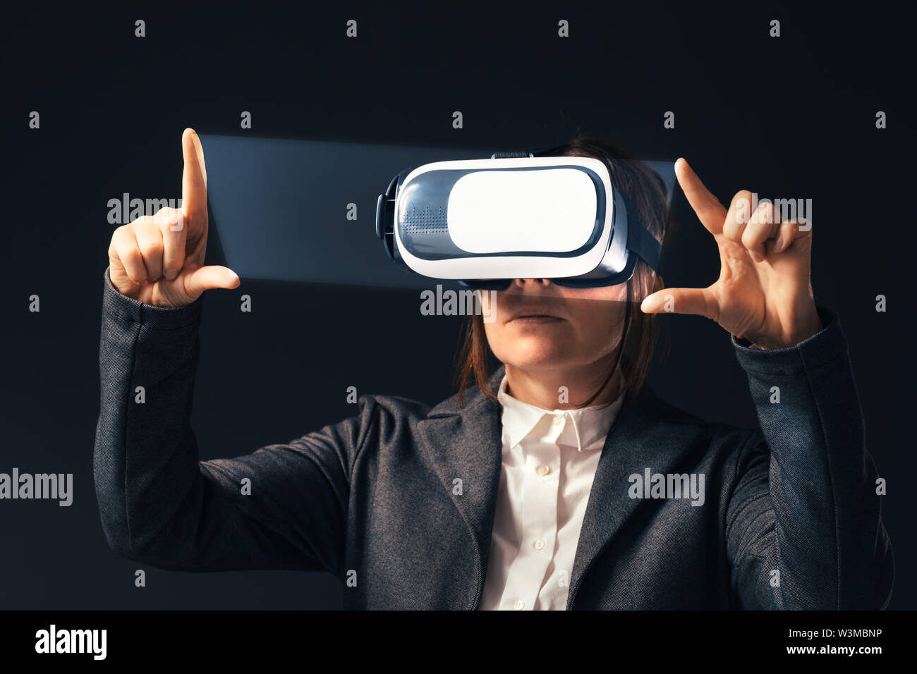 Businesswoman wearing virtual reality headset, digitally enhanced image Stock Photo