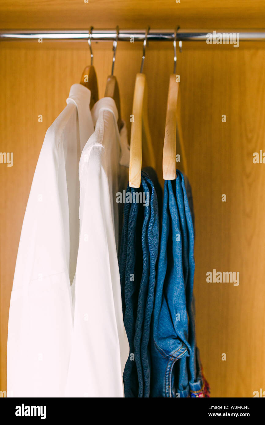 Clothes hanging in wardrobe Stock Photo Alamy
